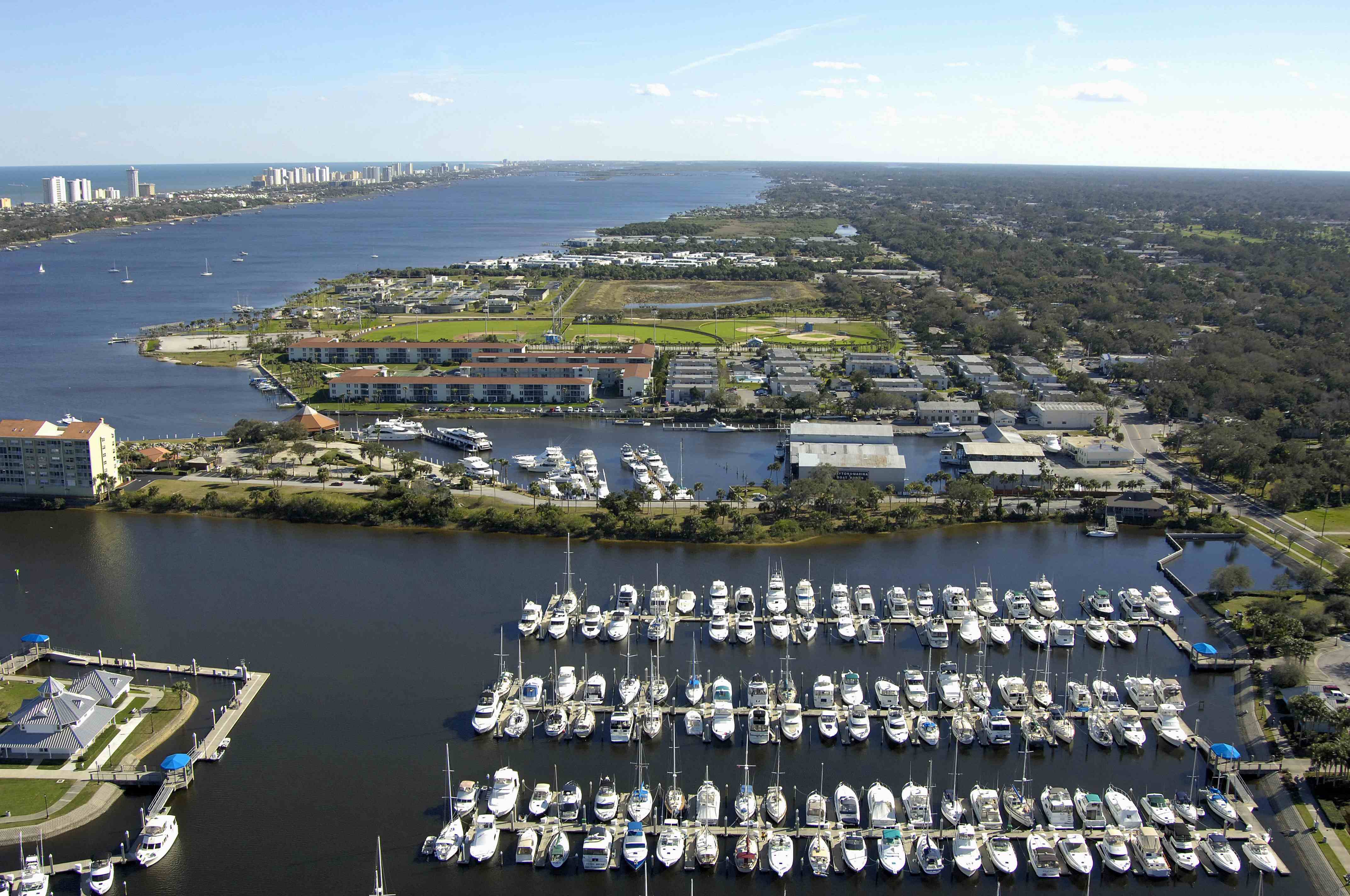 Aerial view of a Daytona Beach marina full of docked boats along the Halifax River
